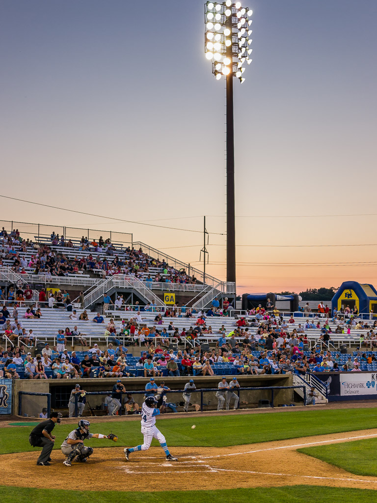 My favorite shot from the night because it encapsulates the feel of a summer evening at the ballpark to me.  The sky, the lights, and the batter whacking a good one.

I took Chris and Sarah -- who are visiting us from the UK -- to a Carolina League (minor league) baseball game in Wilmington and our locals the 