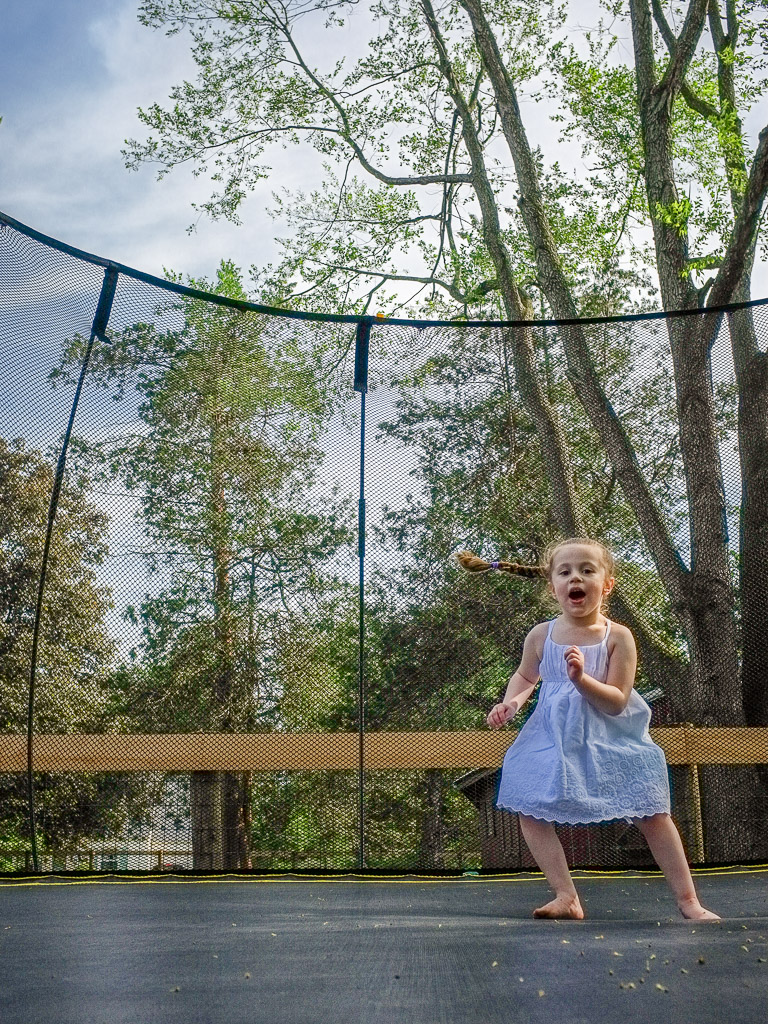 The youngest granddaughter having fun on her cousins' trampoline.  Try as I might I didn't get a good shot of her in the air, but I love this one in general.